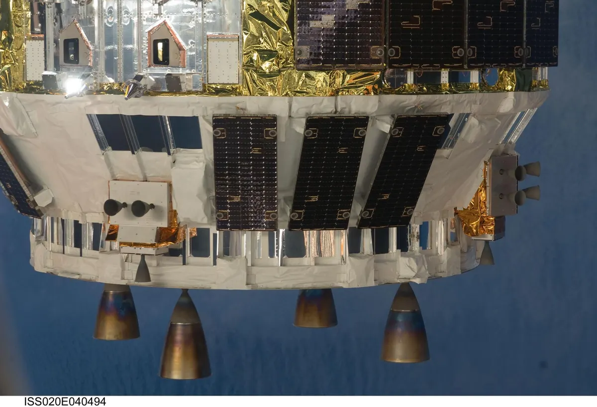 Part of Japan's H-II Transfer Vehicle cargo spacecraft with thruster nozzles, arriving at the International Space Station
