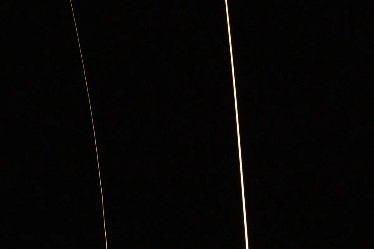 An eight-minute exposure showing the arc of a Falcon 9 launch and its booster landing from Vandenberg
