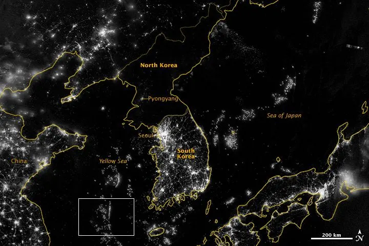 A night-lights map of the Korean peninsula with South Korea brightly lit and North Korea mostly dark