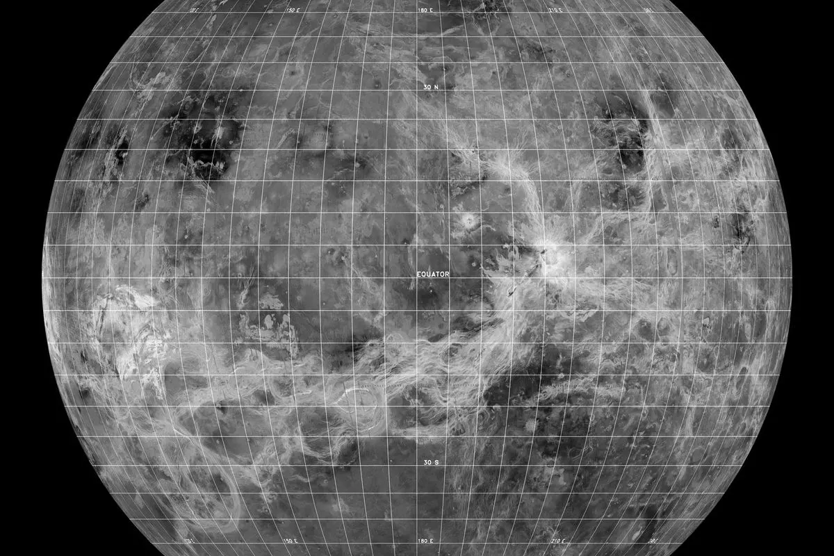 A radar map of Venus on a globe with a latitude and longitude grid